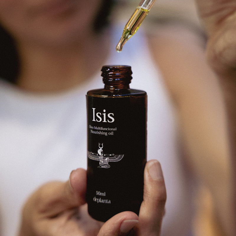 Una mano sostiene Isis mientras cae una gota del gotero